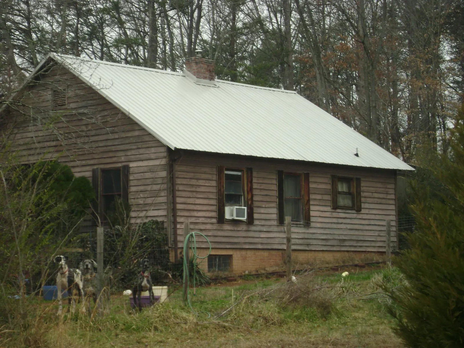 White metal roof on an old wood sided farmhouse, from a Metal Roof Installation job in Iron Ridge